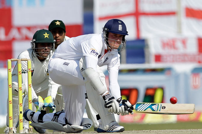 England's Stuart Broad, right, hits the ball watched by Pakistan's Adnan Akmal, left, and Taufeeq Umar, center, during the third day of the second cricket test match of a three match series. ? AP Photo