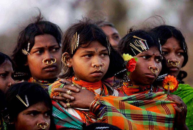 Indian Dongaria Kondh tribal girls watch sacrifice rituals during the annual festival of Niyam Raja in Lanjigarh at the sacred Niyamgiri Hill. ?AP Photo