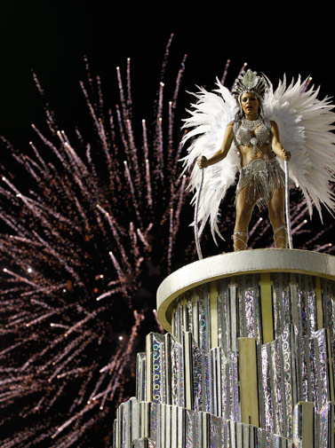 A performer from Renascer de Jacarepagua samba school dances on a float during a carnival parade at the Sambadrome in Rio de Janeiro, Brazil, Sunday Feb. 19, 2012. ?AP Photo