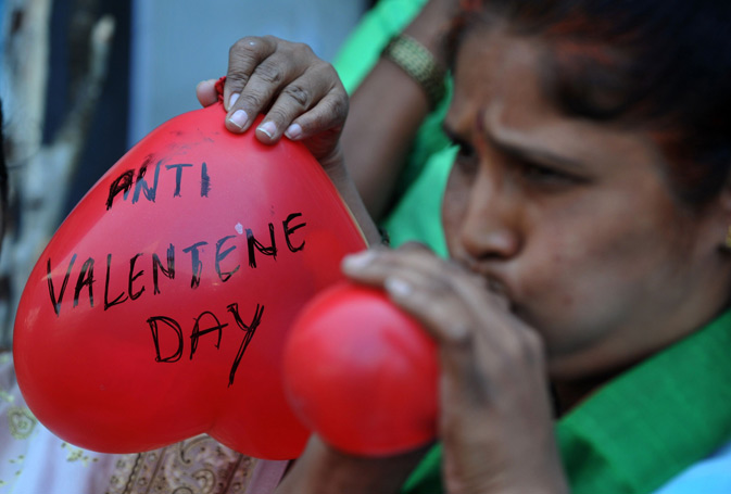 Indian women members of right-wing Bharatiya Janatha Party (BJP) blow heartshaped balloons during a protest to denounce Valentine's Day in Hyderabad. The BJP and right-wing hindu groups strongly oppose Valentine's day celebrations citing them as cultural invasion on the Hindu way of life. – AFP Photo.