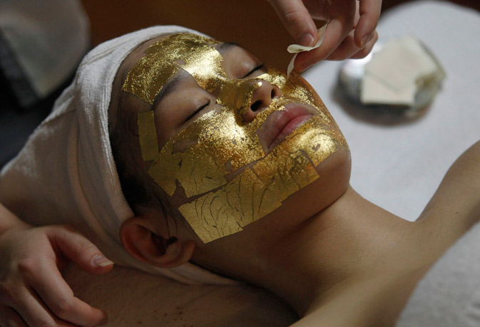 An employee pastes a gold leaf on the face of a client at the Viet My beauty salon in Hanoi. Despite tough economic conditions, including soaring inflation, people in Vietnam seem to be spending heavily as usual on special occasions like Valentine's Day. Viet My is one of a small number of salons in Vietnam that provides 24k gold leaf face mask therapy, said to help make skin whiter. – Reuters Photo.