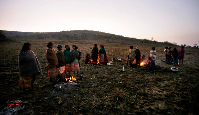 In this photo taken Sunday, Feb. 26, 2012, Indian Dongaria Kondh tribals warm themselves over fires during the annual festival of Niyam Raja in Lanjigarh at the sacred Niyamgiri Hill, about 400 kilometers (249 miles) from the eastern Indian city of Bhubaneswar, Orissa, India. ?AP Photo