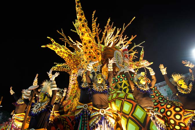 Performers from the Unidos da Vila Isabel samba school parade during carnival celebrations at the Sambadrome in Rio de Janeiro, Brazil, Monday, Feb.20, 2012. Millions watched the sequin-clad samba dancers at Rio de Janeiro's iconic Carnival parade. ?AP Photo