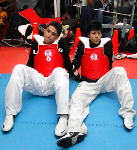 Wearing red chest and back guards made from the material used in bullet-proof vests, the pair, who both recently qualified for the Games in Bangkok, make high-pitched screeches as they take aim, typical of the sport.