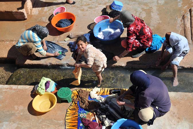Residents and their daughters wash their clothes at the wash-house of Imiter, a village near Tinghir, central eastern Morocco, 160 km from Ouarzazate. The residents of Imiter stage regular sit-ins in front of the Imiter silver mine, one of Africa's biggest silver mines, claiming a better redistribution of the benefits for the region, a higher percentage in job offers for residents and blaming the mine with the drying out of the ground water. ? AFP Photo