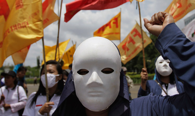 A group of labourers wearing masks protest against the government's plan to raise subsidized fuel prices, in front of the presidential palace in Jakarta. Indonesia's government is considering hiking up fuel prices, which are currently subsidised, by as much as 44 percent this year to reduce the burden of subsidies on the state's budget so that they can use these funds on roads instead, the deputy energy minister told Reuters. ? Reuters Photo