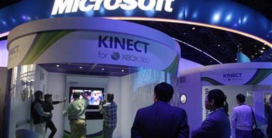 People play a Kinect boxing game on an XBox 360 gaming console at the Microsoft booth during the first day of the International CES in Las Vegas