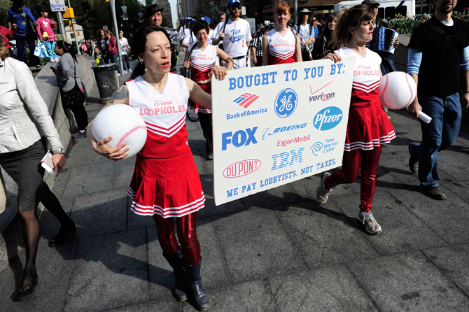 Members of Occupy Wall Street dressed as a baseball team named "The Tax Dodgers" (rear) participate in a rally near Central Park in New York April 14, 2012. – Reuters Photo.