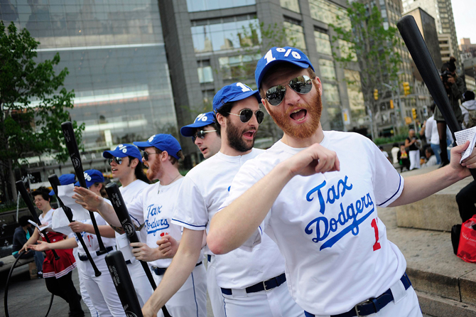 Members of the Occupy Wall Street dressed as a baseball team named "The Tax Dodgers" participate in a rally near Central Park in New York April 14, 2012. – Reuters Photo.