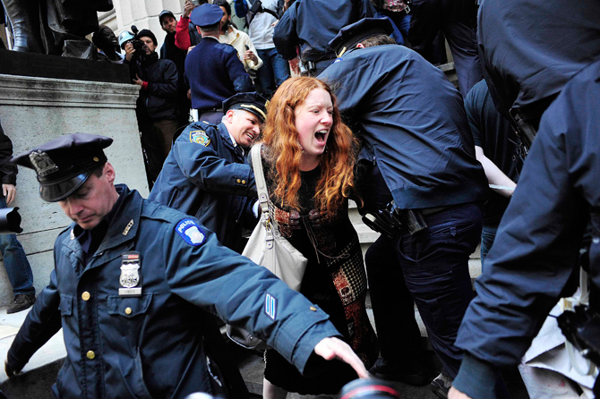 A woman participating in an Occupy Wall Street protest rally is arrested on the steps of Federal Hall on Wall Street across from the New York Stock Exchange in New York April 13, 2012. – Reuters Photo.