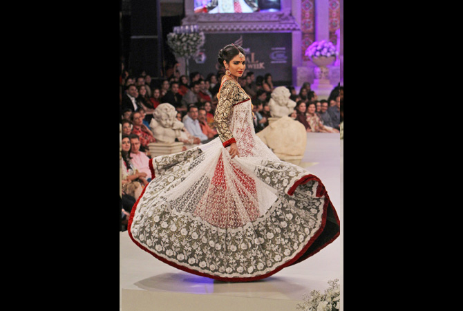 In this Saturday, April 14, 2012 photo, a Pakistani model presents a creation by designer Ruby Shekel, during Bridal Couture Week in Karachi, Pakistan. ? Photo by AP
