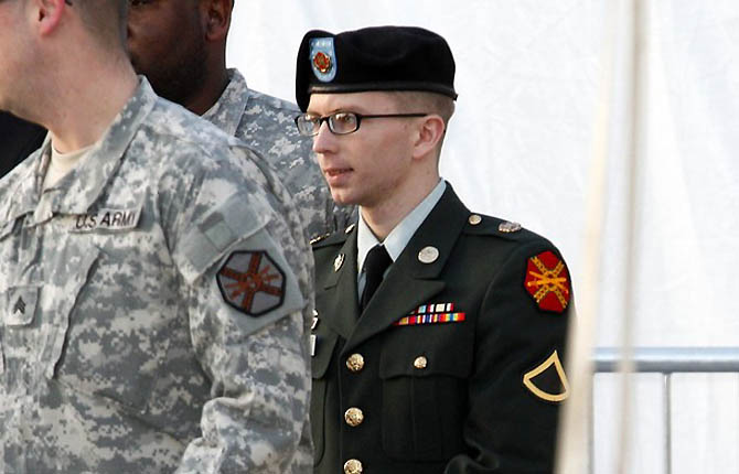 Army Pfc. Bradley Manning, in handcuffs, is escorted out of a courthouse in Fort Meade, Maryland
