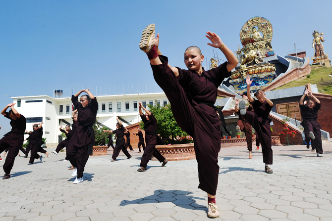 Buddhist nuns practise Kung-fu at the Amitabha Drukpa Nunnery on the outskirts of Kathmandu. ? Photo by AFP.