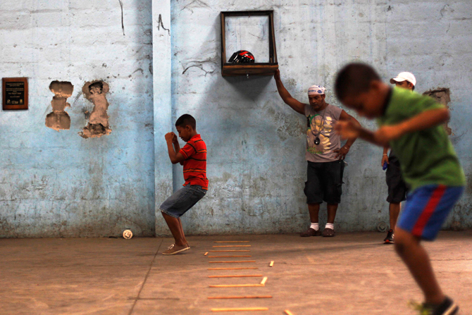 Children jump over wooden sticks during a training session at the Rockero Alcazar gym in the low-income neighbourhood of Curundu in Panama City. ? Photo by Reuters.