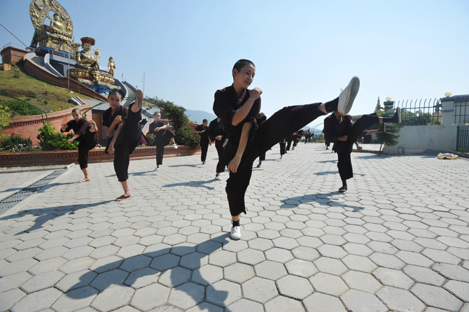 Buddhist nuns practise Kung-fu at the Amitabha Drukpa Nunnery on the outskirts of Kathmandu. ? Photo by AFP.