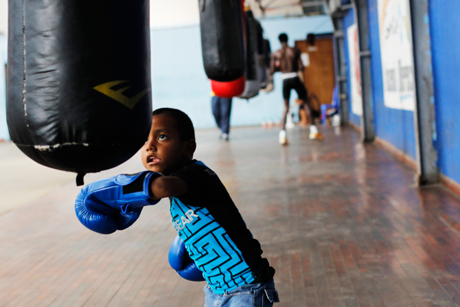A boy practices with a punch bag at the Rockero Alcazar gym in the low-income neighbourhood of Curundu in Panama City. ? Photo by Reuters.
