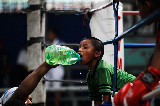 Ulises, 8, drinks water during a training session at the Rockero Alcazar gym in the low-income neighbourhood of Curundu in Panama City. ? Photo by Reuters.