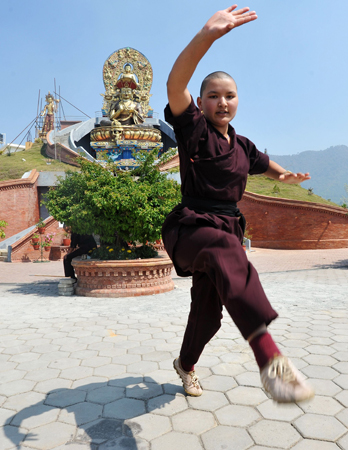 A Buddhist nun practises Kung-fu at the Amitabha Drukpa Nunnery on the outskirts of Kathmandu. ? Photo by AFP.