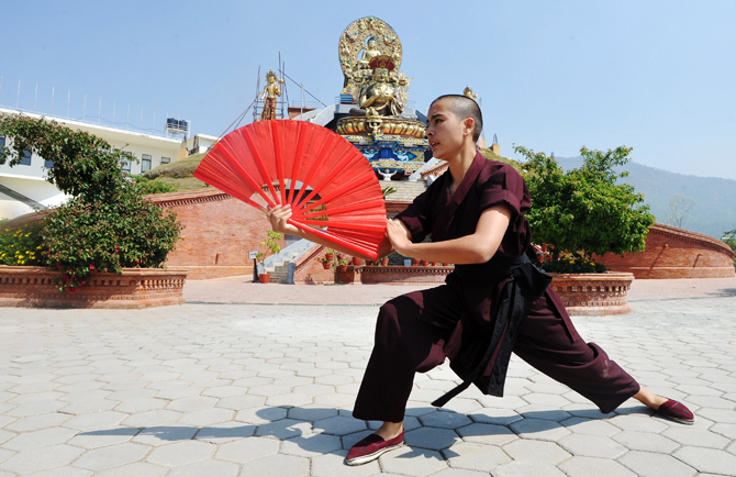 A Buddhist nun practises Kung-fu at the Amitabha Drukpa Nunnery on the outskirts of Kathmandu. ? Photo by AFP.