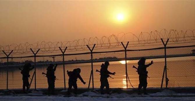 South Korea Kim Jong Il South Korean army soldiers check barbed-wire fence in Hwaseong, South Korea, before sunset Thursday, Dec. 29, 2011. North Korea declared Kim Jong Il's son and successor "supreme leader" of the ruling party, military and the people during a memorial Thursday for his father in the government's first public endorsement of his leadership. (AP Photo/Yonhap) Korea Out