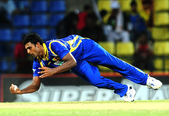 Thisara Perera caught Mohammad Hafeez brilliantly off his own bowling to give Sri Lanka their first wicket. ? Photo by AFP