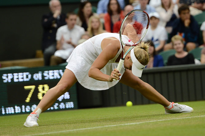 Denmark's Caroline Wozniacki slips on the grass during her first round women's singles match against Austria's Tamira Paszek. – Photo by AFP