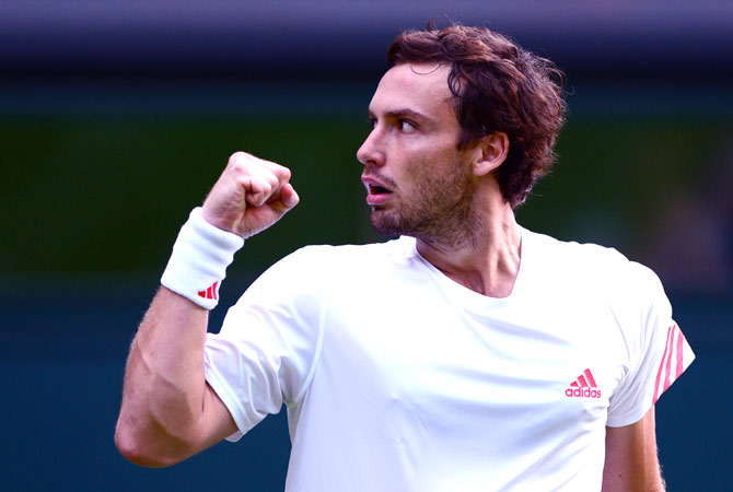 Latvia's Ernests Gulbis celebrates his first round men's singles victory over Czech Republic's Tomas Berdych on the first day of the 2012 Wimbledon Championships tennis tournament at the All England Tennis Club in Wimbledon, southwest London, on June 25, 2012. ? AFP Photo