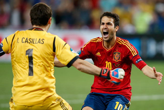 Spain's Cesc Fabregas celebrates with goalkeeper Iker Casillas after scoring the winning penalty goal against Portugal during the penalty shoot-out. ? Photo by Reuters