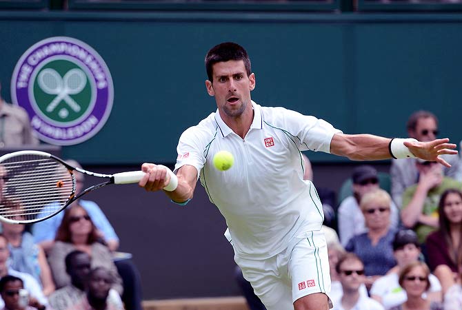 Novak Djokovic of Serbia hits a return to Juan Carlos Ferrero of Spain during their men's singles tennis match at the Wimbledon tennis championships in London June 25, 2012. ? Reuters Photo