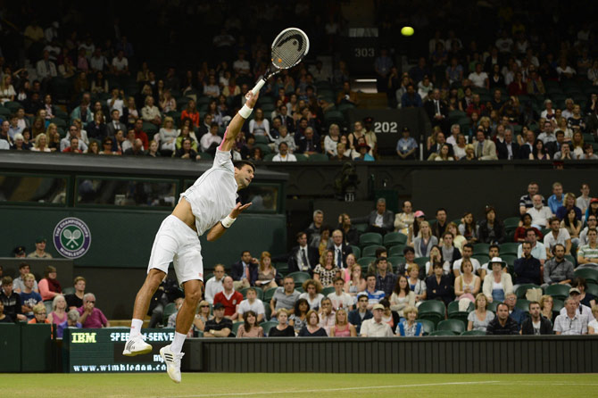 Serbia's Novak Djokovic serves during his second round men's singles victory over US player Ryan Harrison. – Photo by AFP