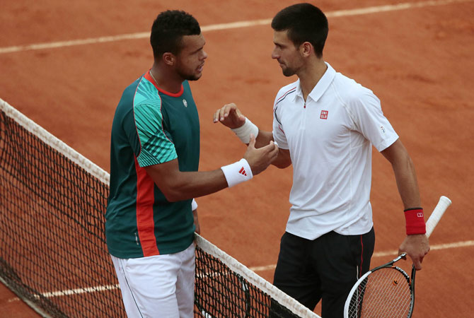 Serbia's Novak Djokovic (R) shake hands with France's Jo-Wilfried Tsonga after winning their Men's Singles. ? Photo by AFP