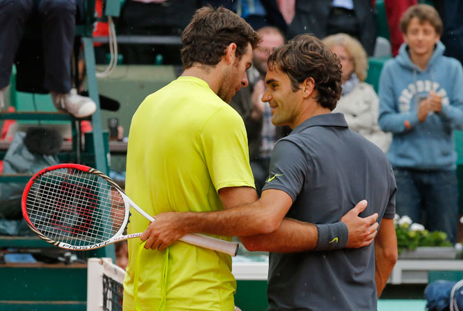 Roger Federer of Switzerland, right, hugs Juan Martin del Potro of Argentina, left, after he won his quarter final match at the French Open. ? Photo by AP