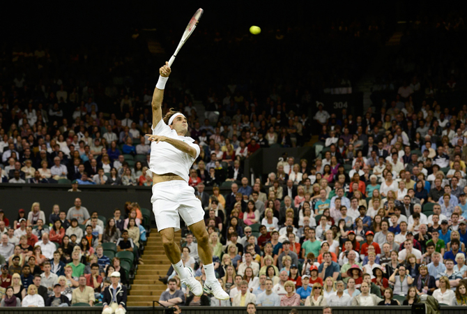 Roger Federer of Switzerland serves to Julien Benneteau of France during their men's singles match. ? Photo by Reuters