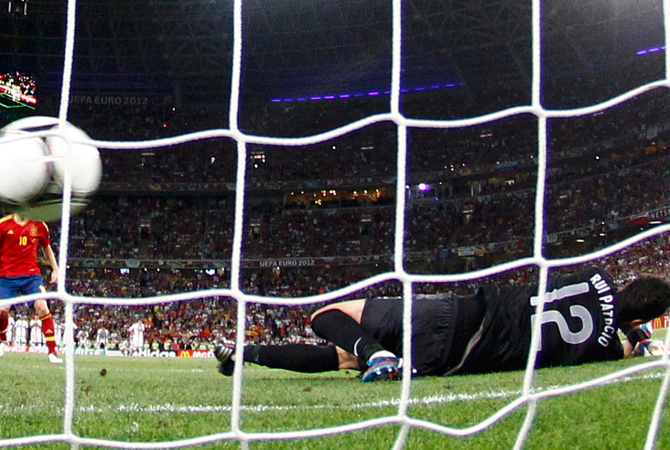 Spain's Cesc Fabregas (Left) scores the winning penalty goal against Portugal's goalkeeper Rui Patricio during the penalty shoot-out in their Euro 2012 semi-finals. ? Photo by Reuters