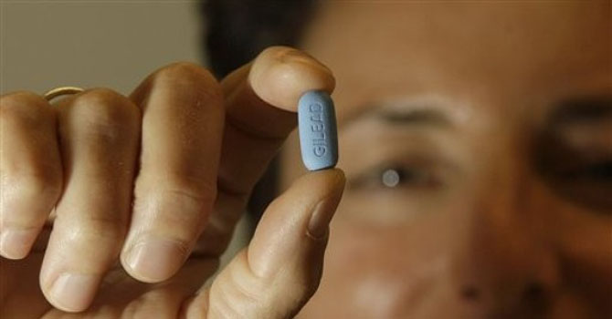 FDA HIV Drug Dr. Lisa Sterman holds up a Truvada pill at her office in San Francisco. – AP