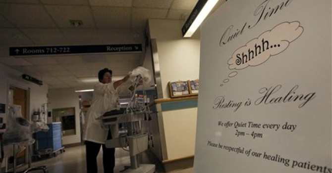 HealthBeat Noisy Hospitals A sign is posted for "quiet time" while Nursing Director Theresa Capodilupo works under dimmed lighting in the hall of the Surgical Trauma Unit at the Massachusetts General Hospital in Boston. – AP
