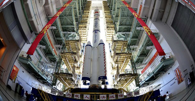 Shenzhou-9 The Shenzhou-9 manned spacecraft, Long March-2F rocket, and escape tower wait to be transferred to the launch pad at the Jiuquan Satellite Launch Center, Gansu. – Reuters