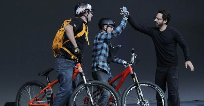 Google co-founder Sergey Brin, right, congratulates two parachutists during a demonstration of Google's new Project Glass, its futuristic, Internet-connected glasses, at the Google I/O conference in San Francisco. – AP Google co-founder Sergey Brin, right, congratulates two parachutists during a demonstration of Google's new Project Glass, its futuristic, Internet-connected glasses, at the Google I/O conference in San Francisco. – AP