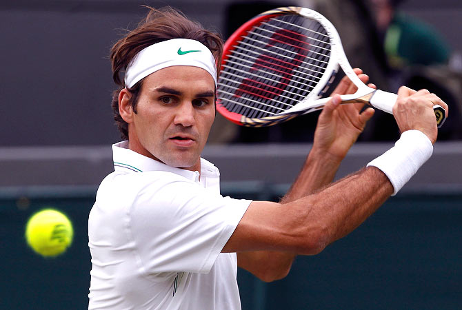 Roger Federer of Switzerland hits a return to Albert Ramos of Spain during their men's singles tennis match at the Wimbledon tennis championships in London June 25, 2012. ? Reuters Photo