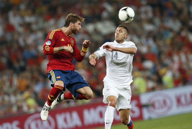 Spain's Sergio Ramos (L) heads the ball against France's Jeremy Menez during their Euro 2012 quarter-final. ? Photo by Reuters