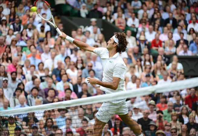 Switzerland's Roger Federer plays a volley during his second round men's singles victory over Italy's Fabio Fognini. – Photo by AFP