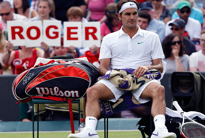 Roger Federer of Switzerland sits on his seat during his men's singles tennis match against Albert Ramos of Spain at the Wimbledon tennis championships in London June 25, 2012. ? Reuters Photo