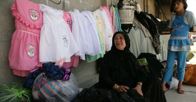 ,-Amina-Osman-(C)-sells-second-hand-clothes-in-the-city-of-Arbil670 Amina Osman (C) sells second hand clothes in the city of Arbil.—AFP Photo