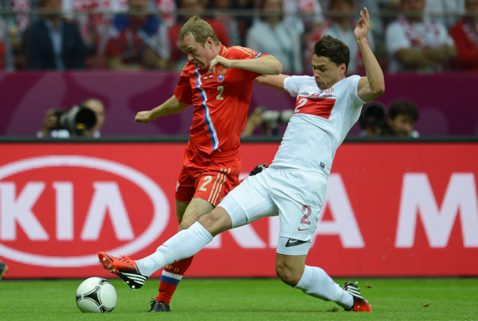 Polish defender Sebastian Boenisch vies with Russian defender Aleksander Anyukov.