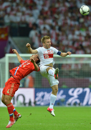 Russian defender Sergey Ignashevich vies with Polish midfielder Jakub Blaszczykowski.