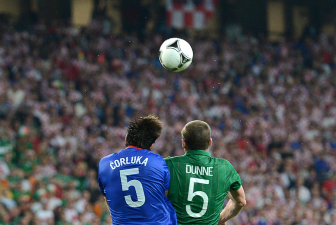 Irish defender Richard Dunne vies with Croatian defender Vedran Corluka during the Republic of Ireland vs Croatia match at the Municipal Stadium in Poznan.