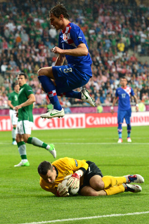 Irish goalkeeper Shay Given vies with Croatian forward Nikica Jelavic during the Republic of Ireland vs Croatia match at the Municipal Stadium in Poznan.