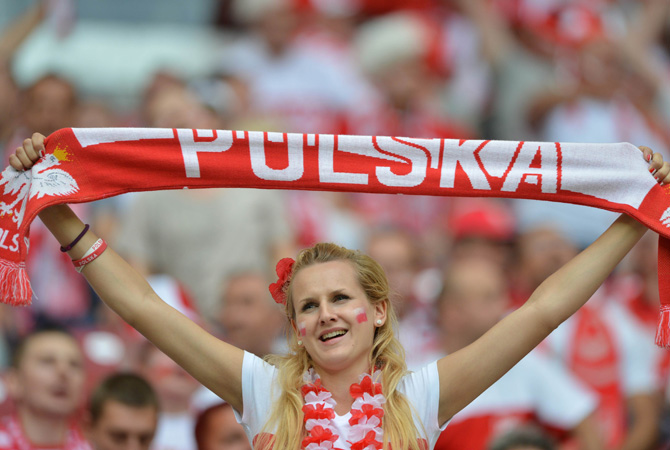 A Polish supporter holds her team banner.