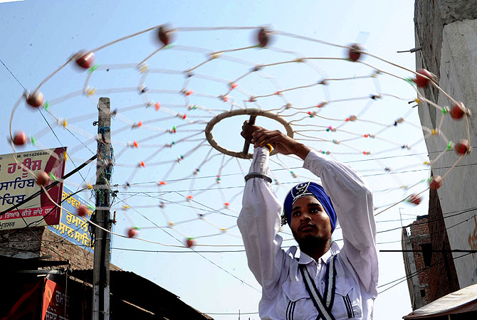 Indian Nihang, a religious Sikh warrior, preforms Gatka, a Sikh martial art, during a procession from the Gurudwara Shaheed Baba Deep Singh temple to the Gurudwara Lohgarh Sahib temple in Amritsar. -Photo by AFP