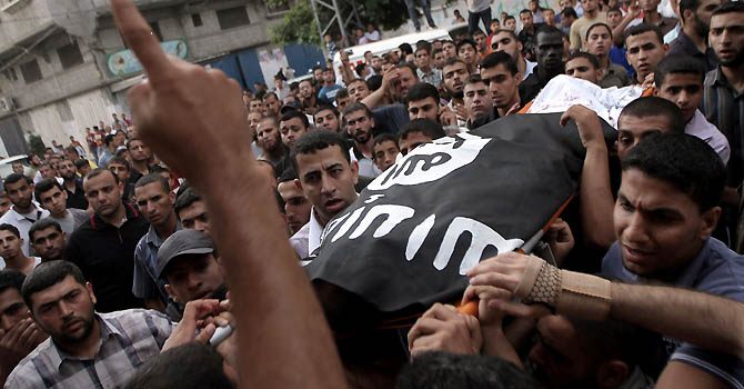PALESTINIAN-ISRAEL-GAZA-CONFLICT-FUNERAL Palestinians carry the body of militant Basel Ahmed during his funeral in al-Bureij refugee camp in the central Gaza Strip on June 22, 2012 after he was killed and two were wounded, one seriously, when Israeli warplanes struck east of Al-Bureij. AFP